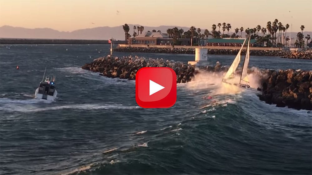 Out-of-control sailboat against the rocks